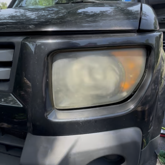 Cloudy, oxidized headlight before professional restoration service